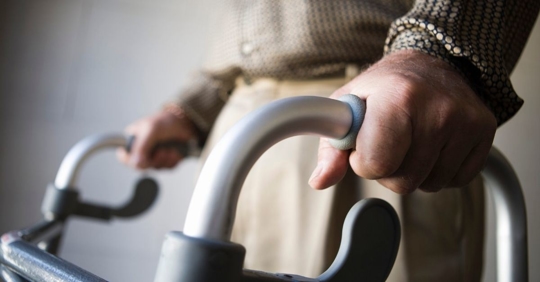 close up of a person using a walker