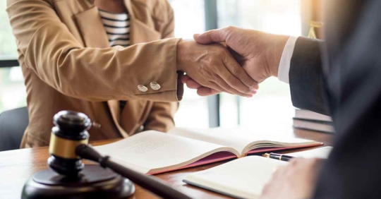 An attorney and someone else shaking hands