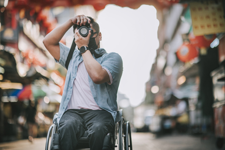 person in a wheelchair taking photos