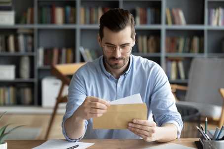 man opening piece of mail