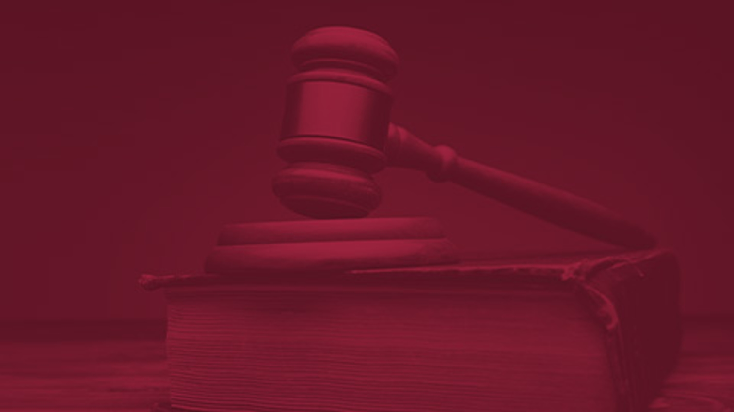 Image of Attorney Scott Rubin sitting at his desk in a suit and speaking